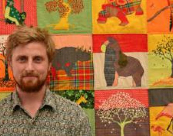 Josh with a prototype of the Communication Quilt