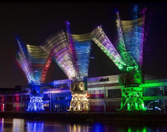 Three cranes dance on the Bristol Harbourside outside M-Shed