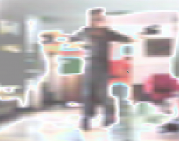 A heavily pixelated image of a person moving in a room