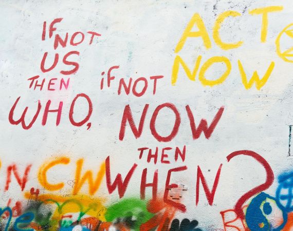 Photo of graffiti saying If not us then who, if not now then when?
