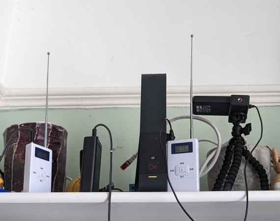 Image of a shelf full of domestic appliances and sound equipment