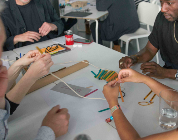 A group of diverse people in a workshop.