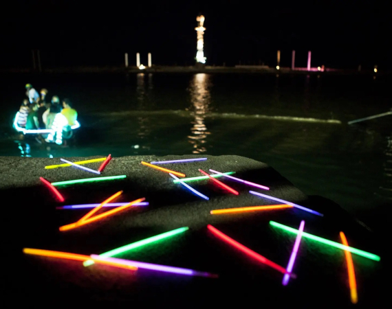 Photo of Playable City Recife project Aquatic Pathways. Light sticks spell "Lets Play" in the dark