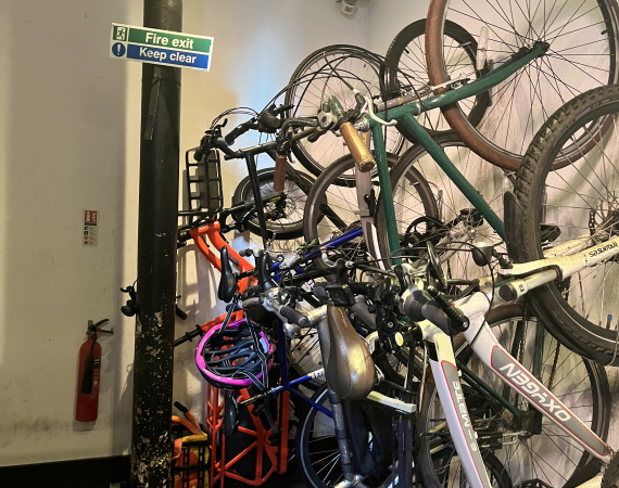 a room pack full of bicycles stored on their back legs. My orange long tail bike is squeezed into the far corner. 