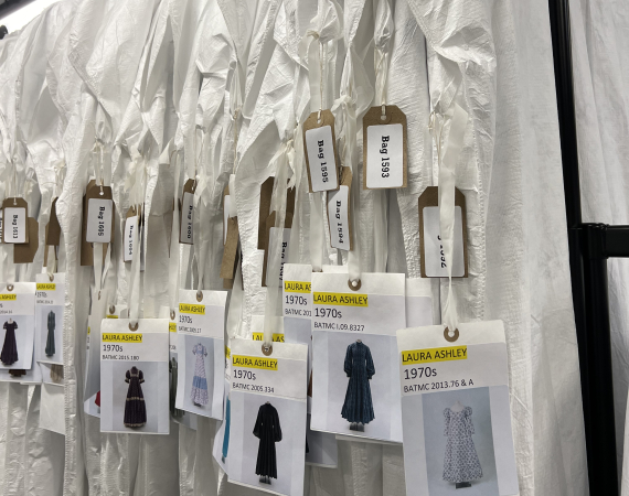 Historical custom garments hanging on a rack