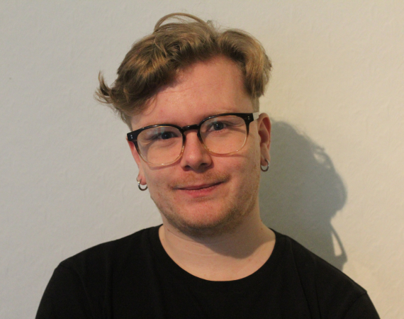 Headshot/portrait picture of Jake's face against a white background. 