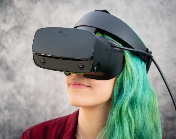 A white woman with green hair, wearing a VR headset