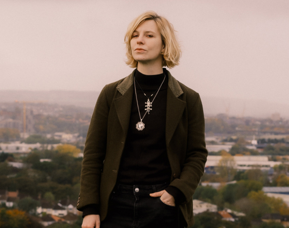 a picture of Simone on Troopers Hill in Bristol with a lovely view of houses in the distance