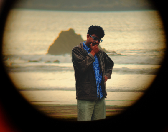 person looking pensively at the sea shore