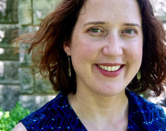 Woman with brown hair smiles at camera