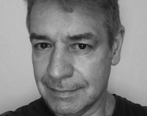 White man in 50s wearing black jumper