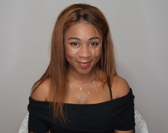 A woman in front of a grey background