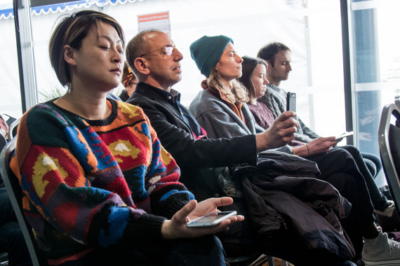 Audience sitting with eyes closed during a demonstration around 5G and touch for Stuart Nolan's 5G Fellowship talk.