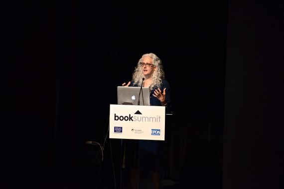 Image of Kate Pullinger, delivering a talk at a workshop, against a black background